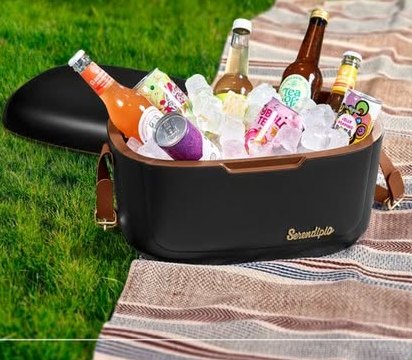 Black cooler box full of ice and drinks on a picnic blanket