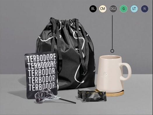 Gift hamper with a drawstring bag, mug, sweets and snacks