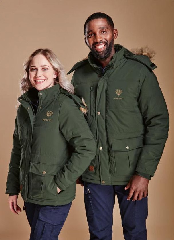A man and a woman wearing dark green branded parka jackets with logos on the chest